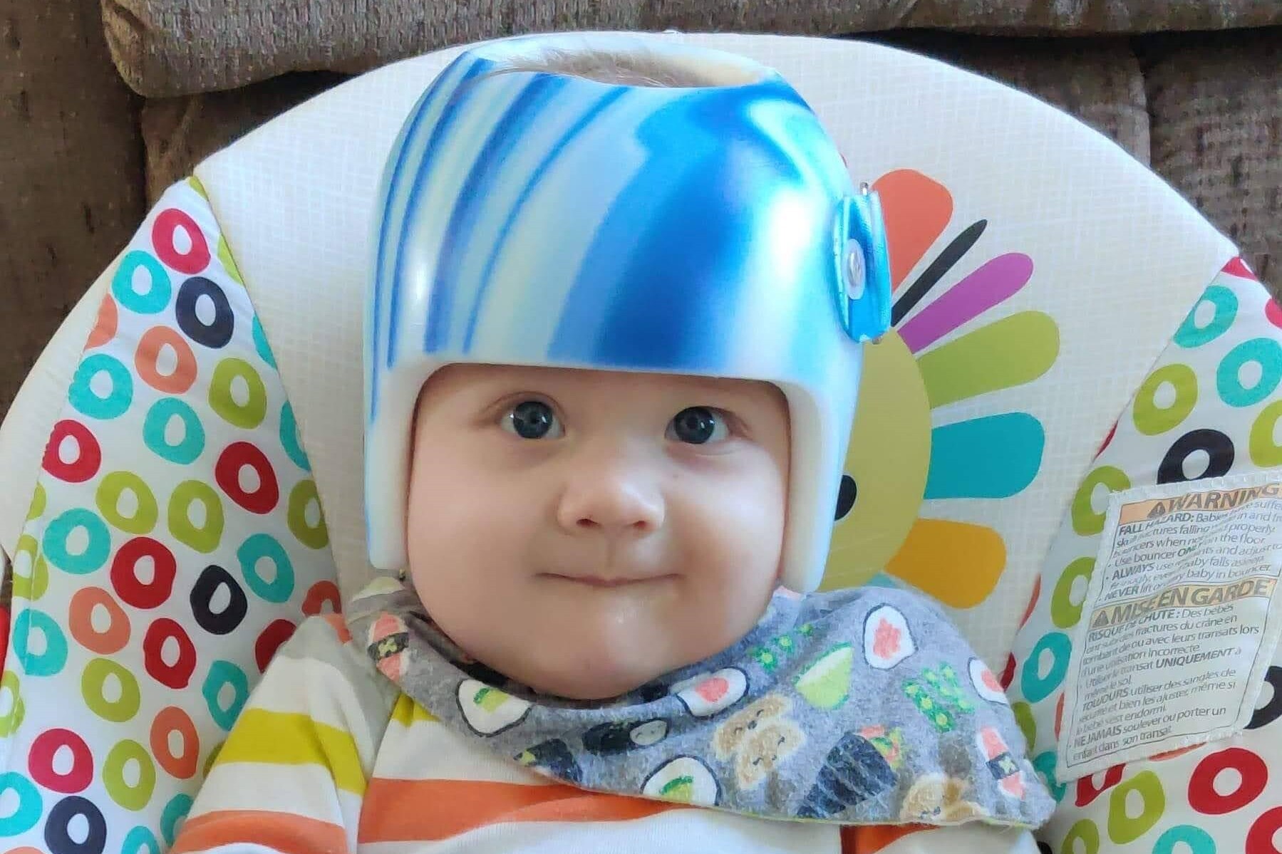 Infant Boy Wearing a Helment